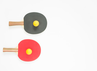 Sport background. Red and black ping-pong rackets and balls. Flat lay, top view.