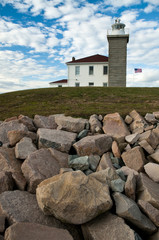 Watch Hill lighthouse sits atop rocky barrier in Rhode Island.