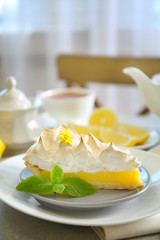 Piece of delicious lemon meringue pie on plate