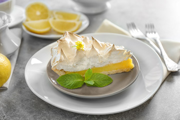 Piece of delicious lemon meringue pie on plate