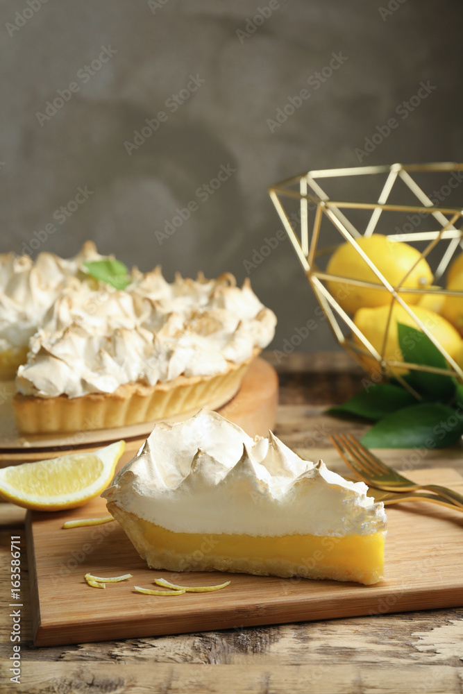 Sticker piece of yummy lemon meringue pie on wooden table