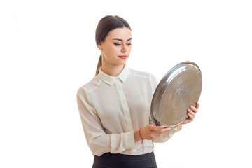 the young waitress holding a large round tray for eating