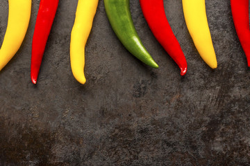 cayenne chilli peppers on rusty metal background