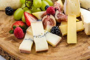 Cheese plate with bread grapes and strawberries