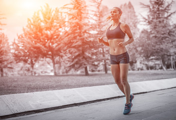 beautiful young woman running on road