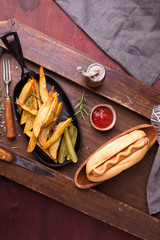 Fast food, hot dog with yellow mustard and french fries. Top view