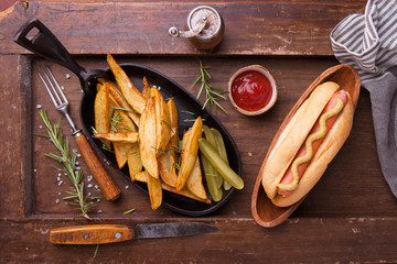 Fast food, hot dog with yellow mustard and french fries. Top view