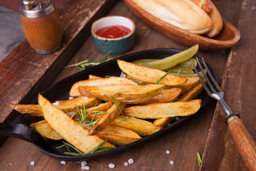 French fries with ketchup on wooden background. Close up