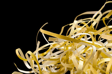 Closeup shredded paper texture and reuse yellow color,colorful paper scrap of document on black...