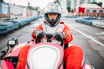 Karting race, go cart driver in helmet