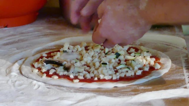 Putting mushrooms on pizza in rustic kitchen, UHD