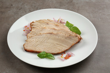 Plate with delicious sliced turkey on table