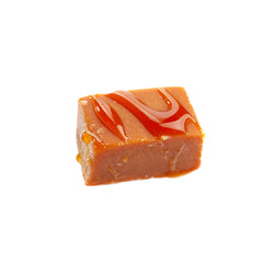 Tasty caramel sauce with candy on white background