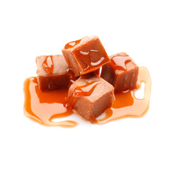 Tasty caramel sauce with candies on white background