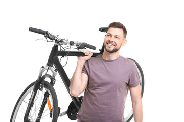 Handsome young man with bicycle on white background