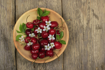 Fototapeta na wymiar Fresh garden cherry in wooden table