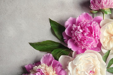 Composition with beautiful peony flowers on light textured background, closeup