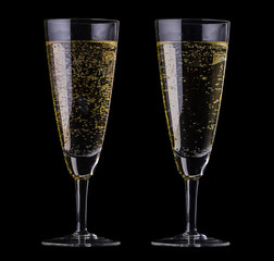 two champagne glasses on black background