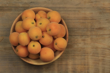 Apricot fruit. Fresh organic apricots on wooden background.