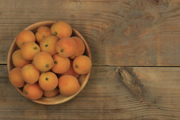 Apricot fruit. Fresh organic apricots on wooden background.