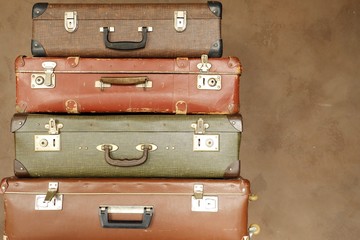 Colorful retro suitcase on a beige background