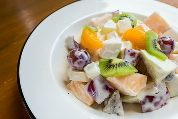 White bowl of fresh healthy fruit salad.