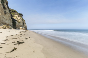 Secluded Dume Cove beach with motion blur water near Los Angeles in Malibu, California.