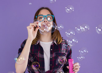 Young cute girl blows bubbles, pretty woman  