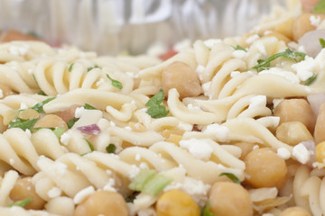  a close or macro view of fusilli or spiral pasta, food in a dish with chickpeas 