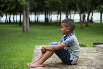 Young asian boy stay alone and sadness