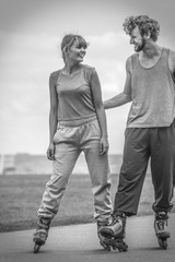 Woman and man couple rollerskates outdoor