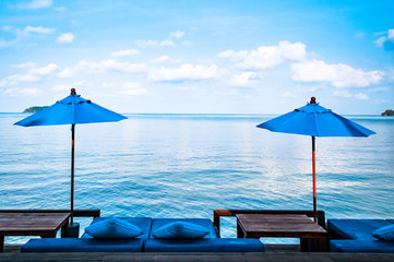 Beach umbrellas, beach bed and blue sea
