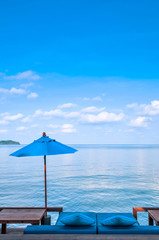 Fototapeta na wymiar Beach umbrellas, beach bed and blue sea