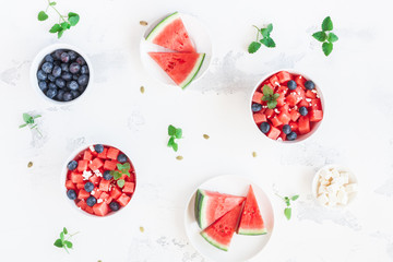 Watermelon salad and watermelon slices on white background. Top view, flat lay