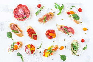 Traditional spanish tapas on white table. Brushetta set. Flat lay, top view