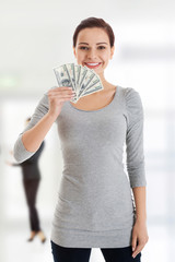 Beatiful casual woman holding money.