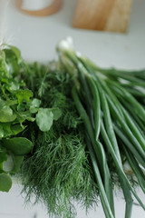 Farmers market fresh bunch of organic onions,  dill, lettuce on the kitchen
