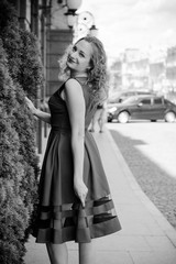 Naklejka premium Woman walk in city at good sunny day with pretty mood and waiting happiness