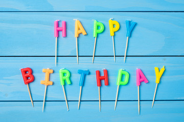 Birthday candles on blue wooden table