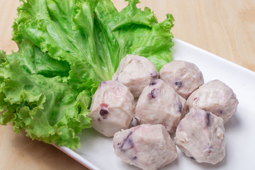 Meat ball with Green vegetable on white plate, Components used in making shabu or Sukiyaki and turn over the meat.