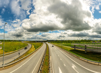 Highway road with fast moving cars. Summer nature landscape panorama.