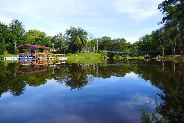 Fototapeta premium Photo picture a blue sky and a lake, meadow grass and clouds float white