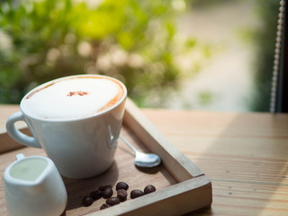 Hot coffee on wooden table in the morning