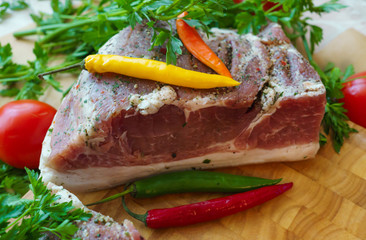 Piece of pork salted in the traditional way, along with chili.