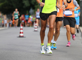 athletes run the marathon on the city road