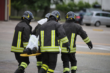 Firefighters with the stretcher after a tragic road accident