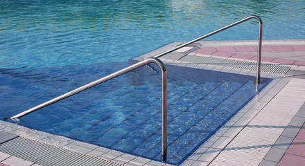 swimming pool with ladder and the steel handrail in an exclusive