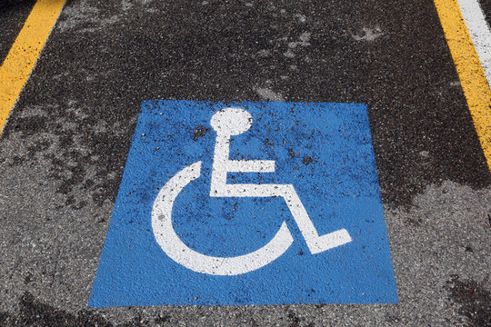 wheelchair symbol in the car parking for disabled people