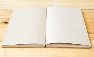 Fototapeta premium Open hand made book on wooden table.