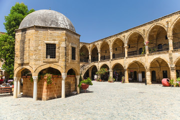 NICOSIA, NORTHERN CYPRUS.View on Buyuk Han (the Great Inn), largest caravanserai in Cyprus. Nicosia - obrazy, fototapety, plakaty